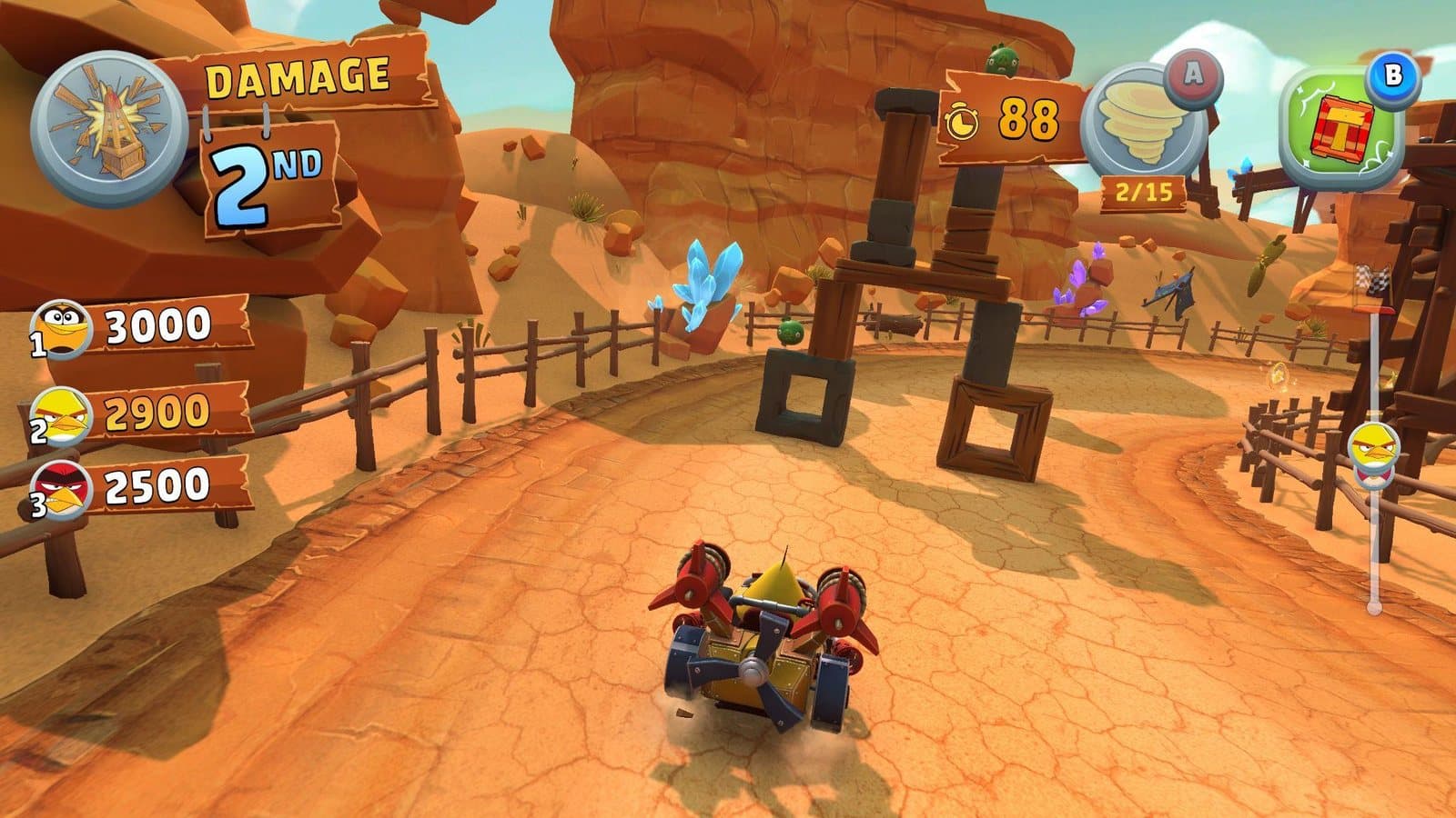 In-race HUD in the Rocky Canyons theme, showing damage score and 2nd position, the top three damage scores, the ability charge at 2 of 15 and the held power-up.